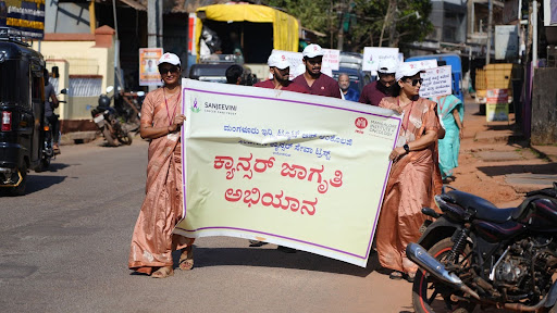 M.I.O. and Sanjeevini Cancer Seva Trust staff lead the "Arive Shakthi" Cancer Awareness Rally through Kumta