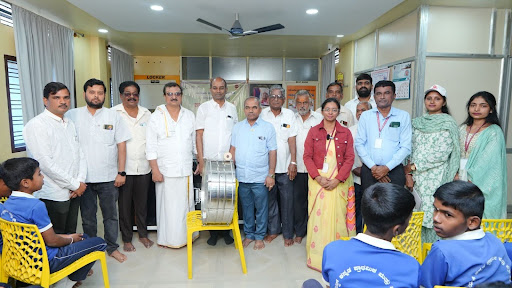 Distinguished guests, Ganga Sahakari Sangha directors, and M.I.O. representatives gather at the inauguration of the Cancer Awareness Rally in Ranebennur