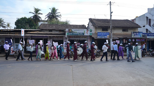 M.I.O. staff and volunteers march through Shikaripura's main roads with placards and pamphlets