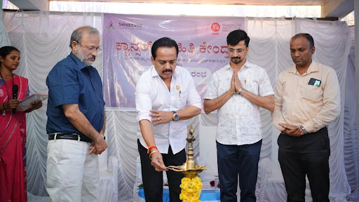 MLA Ashok Kumar Rai inaugurates the Cancer Information Centre, Puttur, with a traditional lamp lighting ceremony, joined by Dr. D. Suresh Rao and dignitaries from M.I.O. and Sanjeevini Cancer Seva Trust.