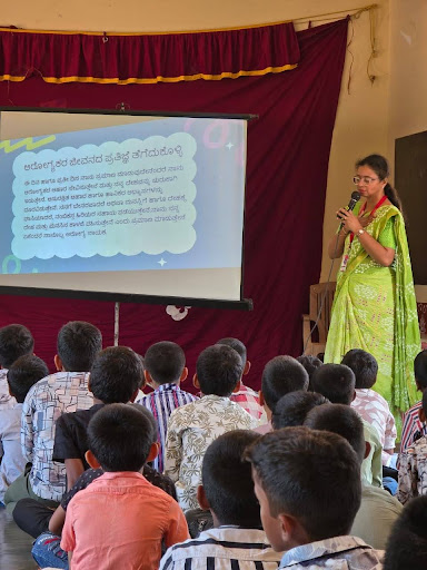 An M.I.O. team member delivers a health awareness presentation to students at Ammunje School