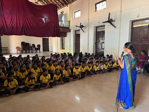 An M.I.O. team member addresses the full school assembly at B.E.M. School, Mangalore