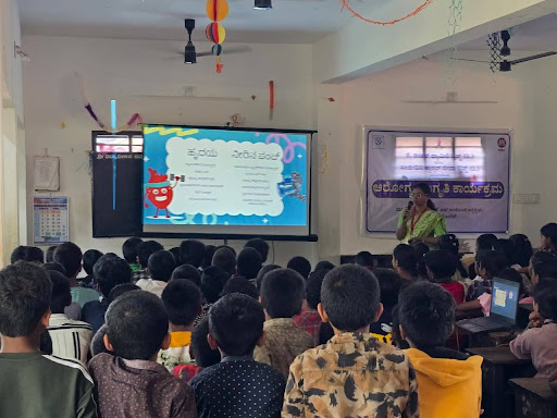 M.I.O. staff deliver an interactive health awareness session at Sri Vidyavilasa School using a visual presentation